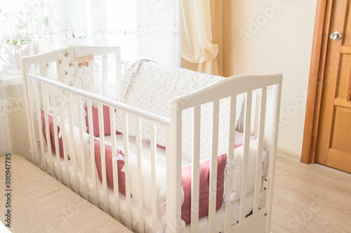 Baby bed crib with white and Burgundy color pillows with laces