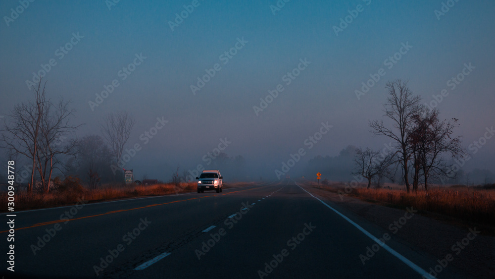 Wide angle view of single Car on highway road on sunset evening night in countryside, ruler view