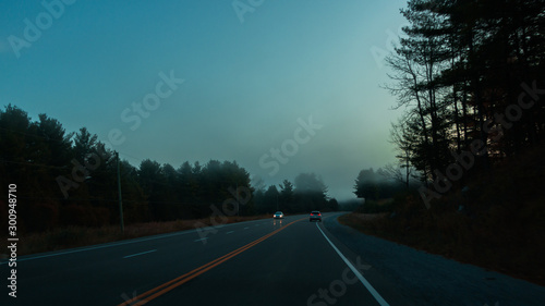 Wide angle view of single Car on highway road on sunset evening night in countryside, rural view