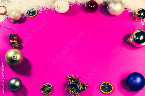 pink background with decoration for christmas, baubles, angel and snow