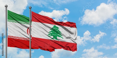 Foto Iran and Lebanon flag waving in the wind against white cloudy blue sky together