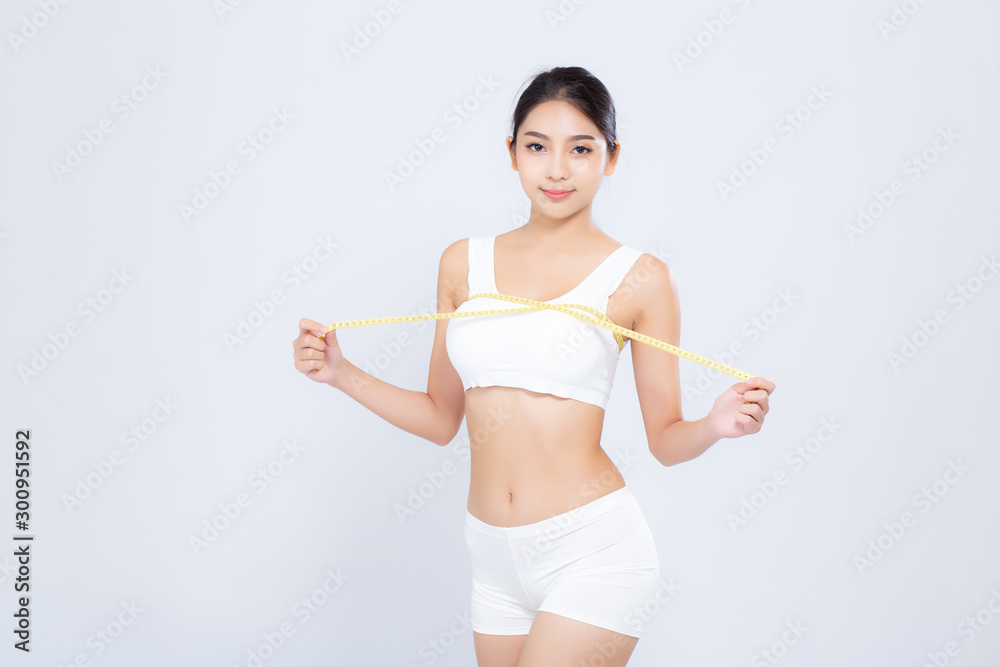 Beautiful portrait asian woman diet and slim with measuring breast and augmentation isolated on white background, girl have cellulite loss with tape measure, health and wellness concept. Beautiful portrait asian woman diet and slim with measuring breast and augmentation isolated on white background, girl have cellulite loss with tape measure, health and wellness concept.