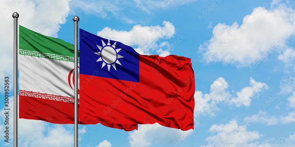 Naklejka premium Iran and Taiwan flag waving in the wind against white cloudy blue sky together. Diplomacy concept, international relations.