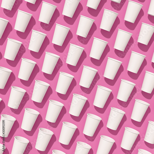 Pattern of empty paper disposable cups are laying on a background with hard shadows