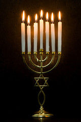 Jewish Hanukkah menorah on black background. 