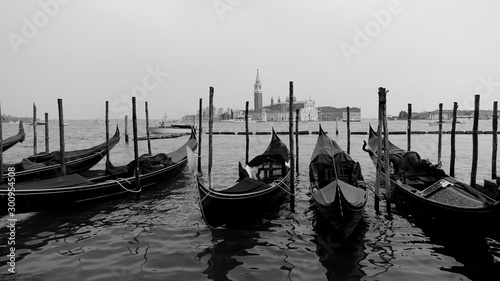 Black and white photo of gondola and gondolier taken in the beautiful city of Venice, Italy