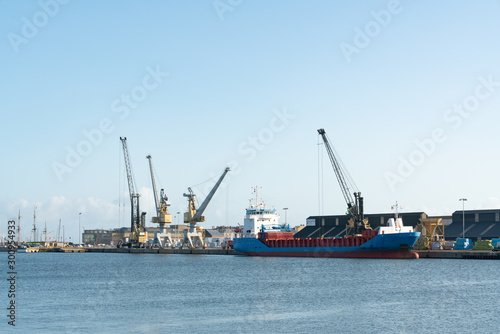 loading a freight ship in the commercial port of Saint-Malo on the coast of Brittany © makasana photo