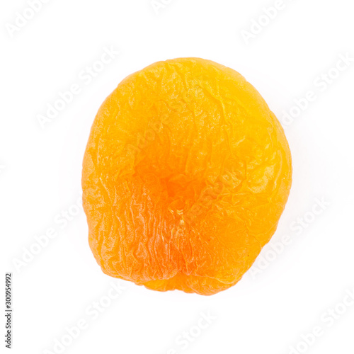 Dried apricot ingredient closeup isolated on a white background. One orange apricot fruit with clipping path