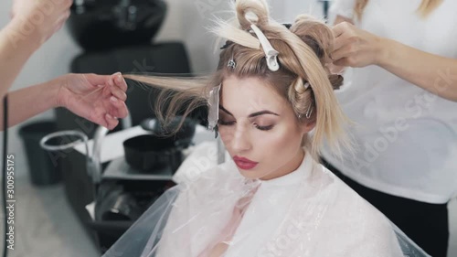 Close up, hairdressers do hair coloring for woman in beauty studio