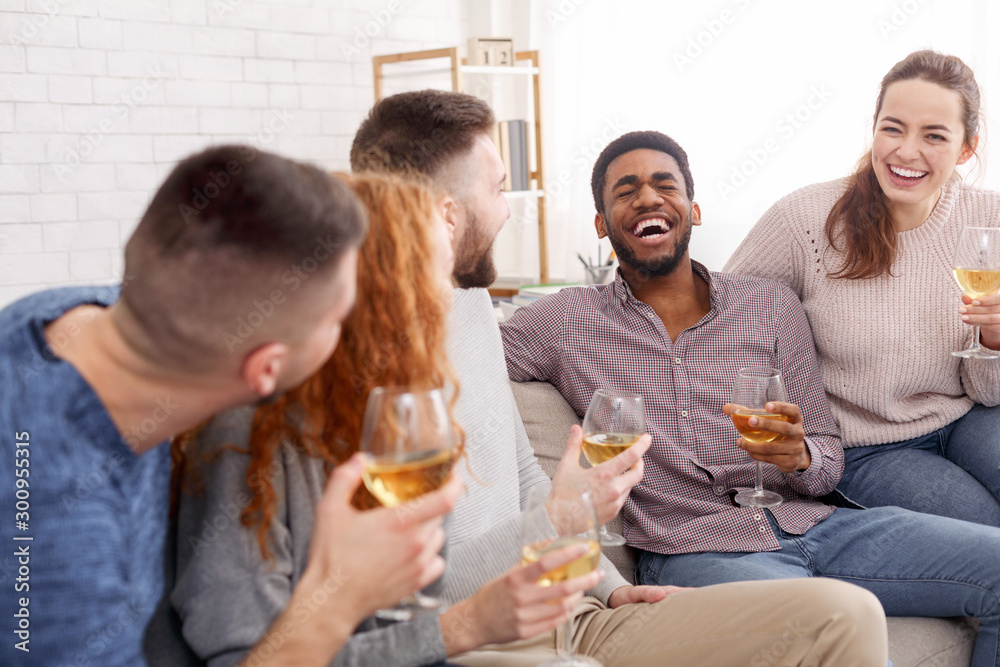 Home gatherings. Friends drinking wine and chatting Home gatherings. Friends drinking wine and chatting