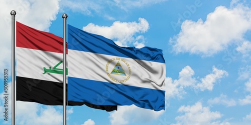 Iraq and Nicaragua flag waving in the wind against white cloudy blue sky together. Diplomacy concept, international relations.