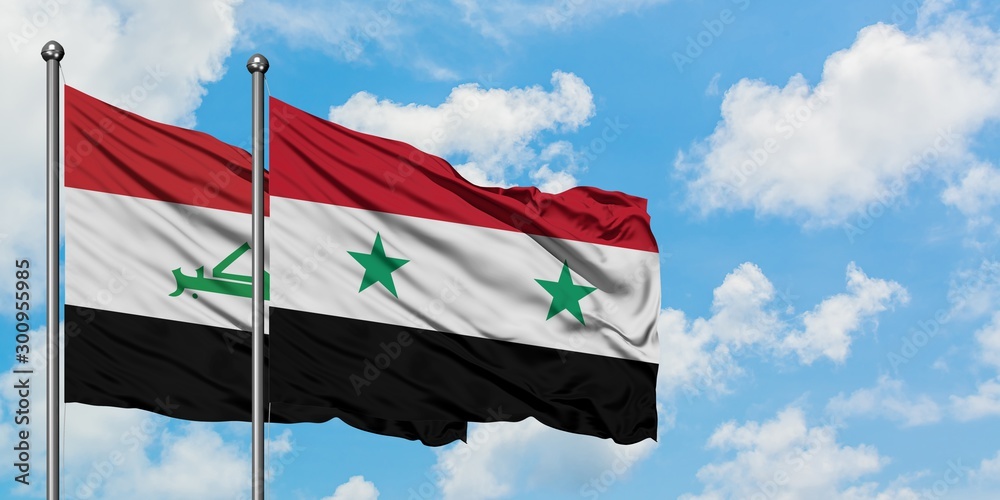 Iraq and Syria flag waving in the wind against white cloudy blue sky together. Diplomacy concept, international relations.