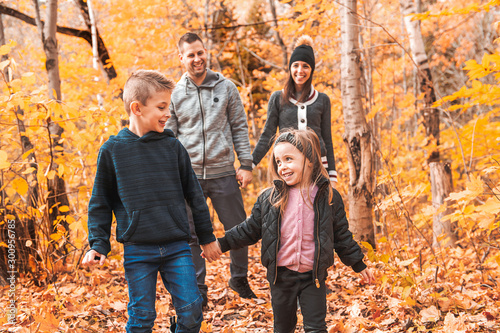 A portrait of a young family in the autumn park