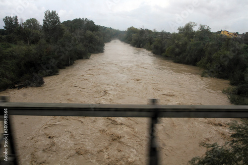 Capua, Italy - 6 November 2019: The Volturno river in flood after the heavy rains of the last days photographed by the running train photo