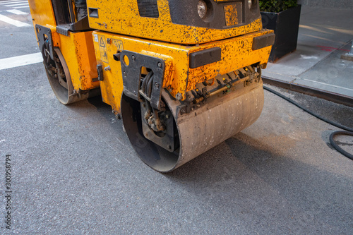 Urban city street black top tarmac patch up work and repairs with a 3 ton asphalt blacktop roller