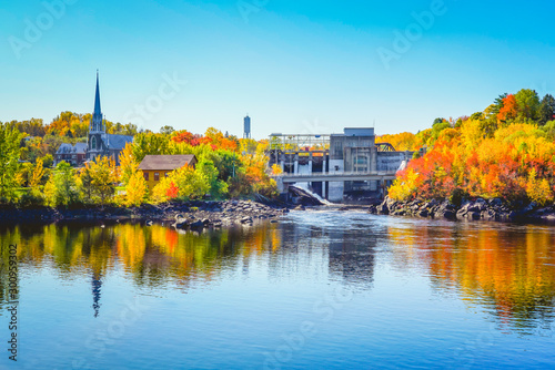 Autumn Landscape View of Color Trees with Dam and Chruch in Fall Season