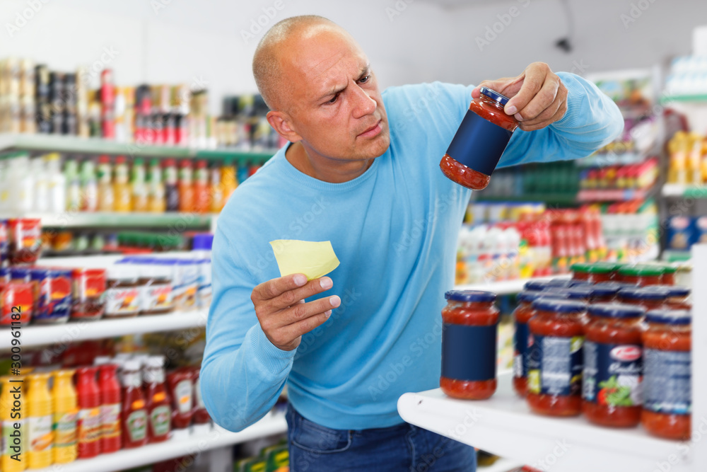 Portrait of middle-aged man making purchases in the grocery store