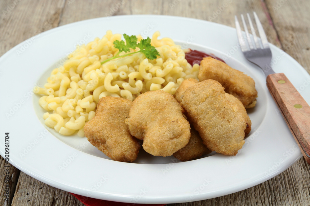 plate of chicken nuggets and coquillettes pasta plate of chicken nuggets and coquillettes pasta