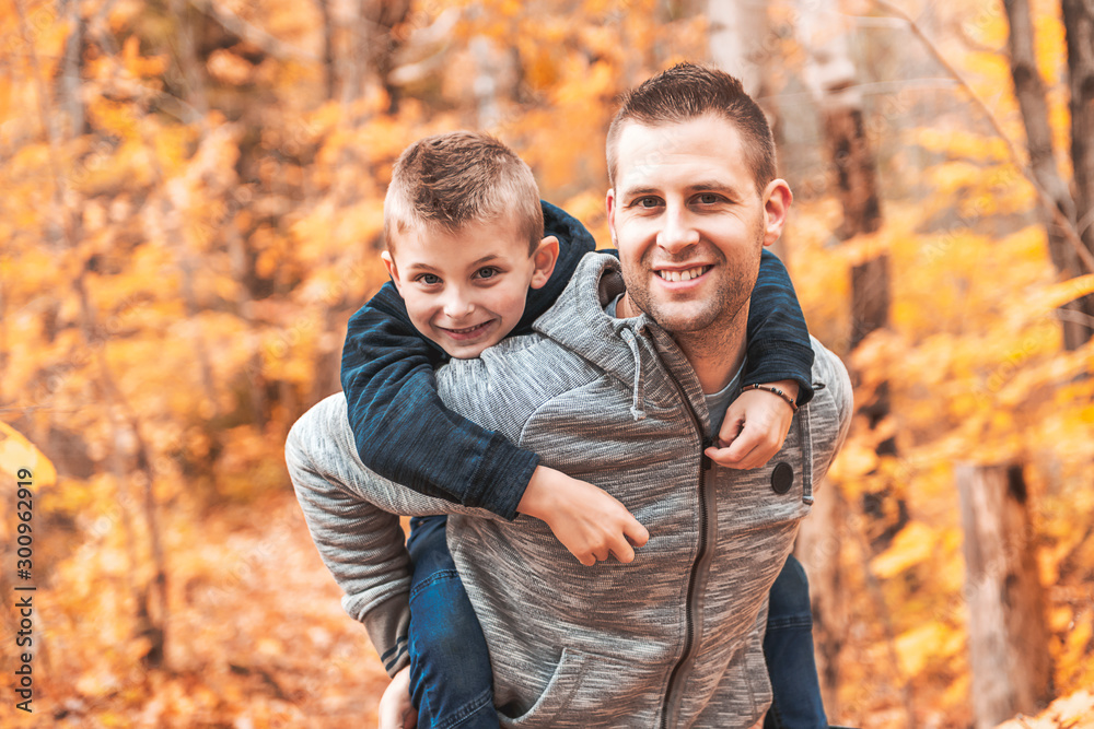 A portrait of a father with child in the autumn park A portrait of a father with child in the autumn park