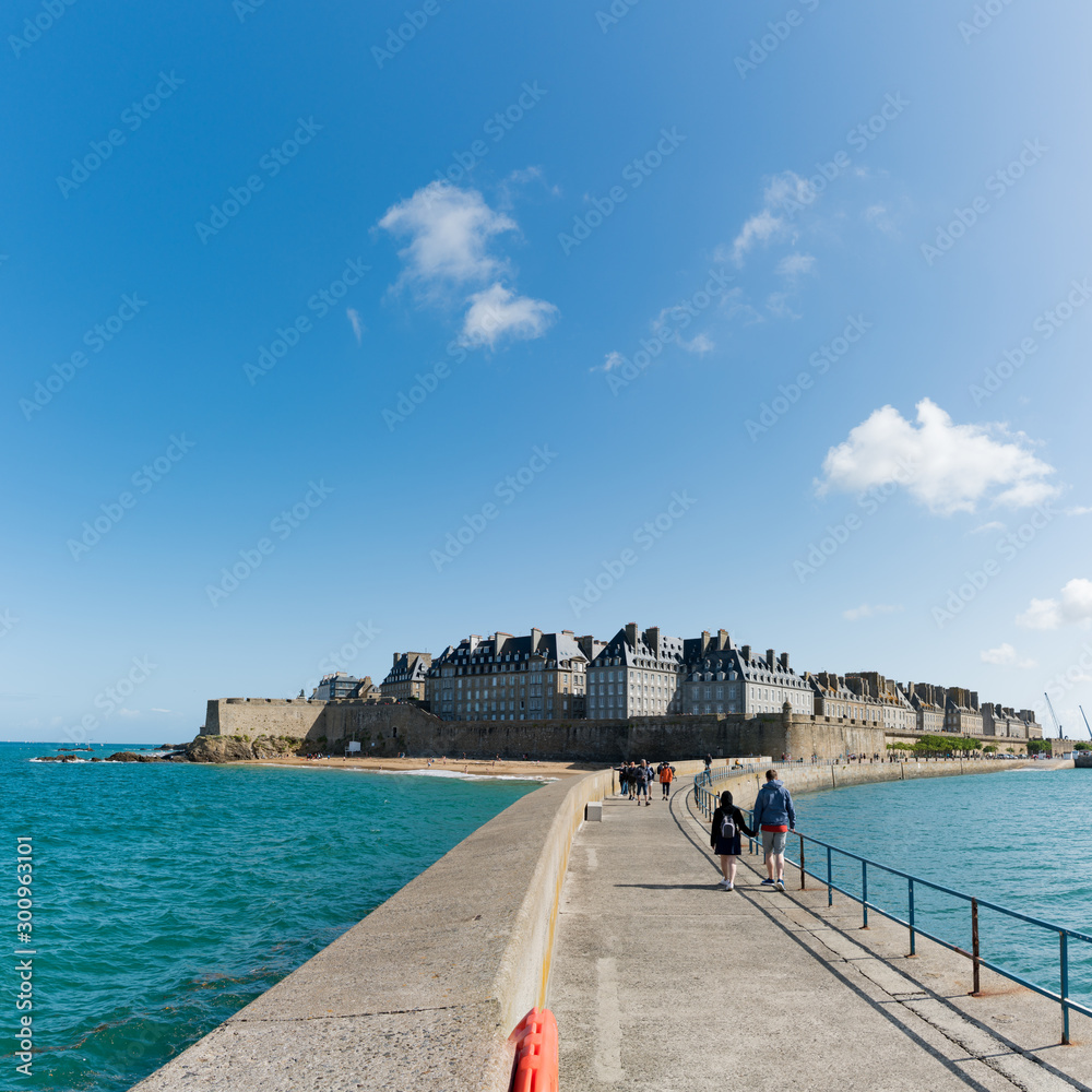 historic French town of Saint-Malo in Normandy seen from the harbor wall jetty