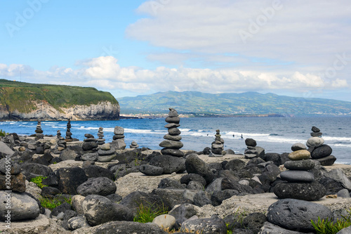Stack of zen stones on beach.Cairns on the beautiful sea beach of Praia do Areal de Santa Barbara, island of San Miguel, Azores, Portugal.