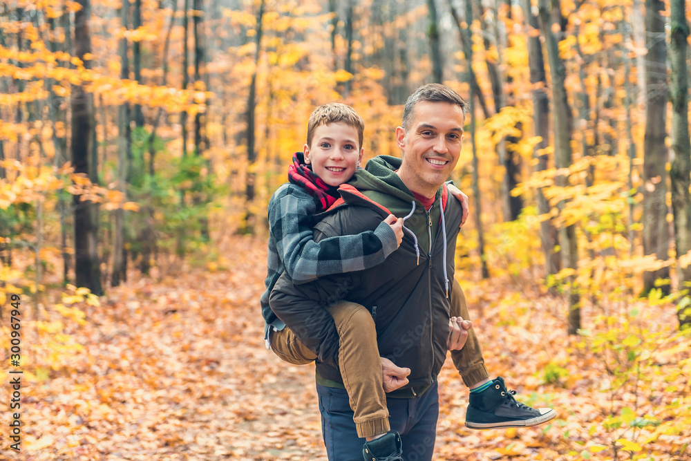 A portrait of a father with child in the autumn park