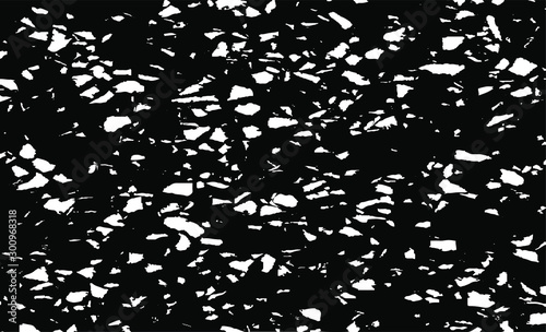 Small uneven spots and particles of debris. Abstract vector texture.  Distressed uneven background. Grunge texture overlay with fine grains isolated on white background. Vector illustration. EPS10.