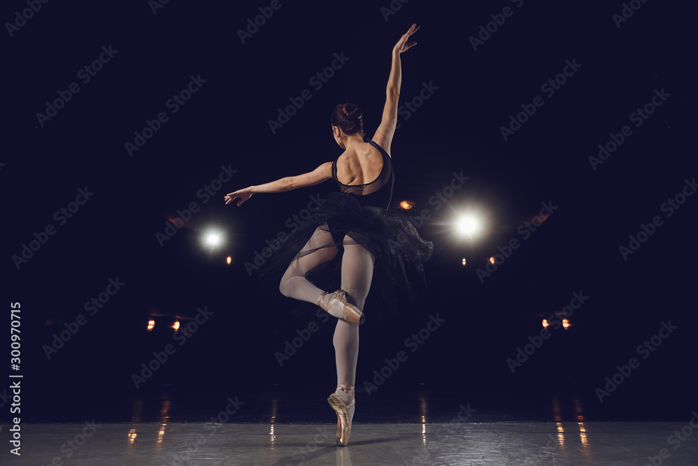 Obraz premium Woman ballet dancer on black background.