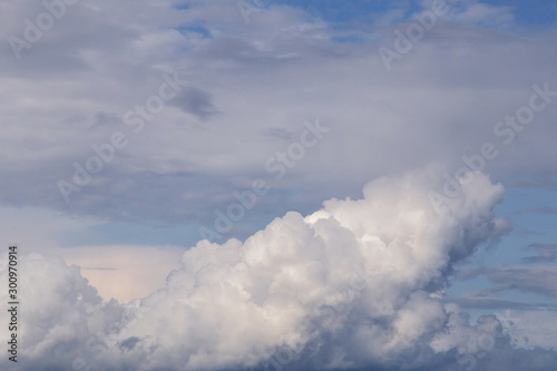 Cumulus big white fluffy clouds texture, against blue sky background, heaven 