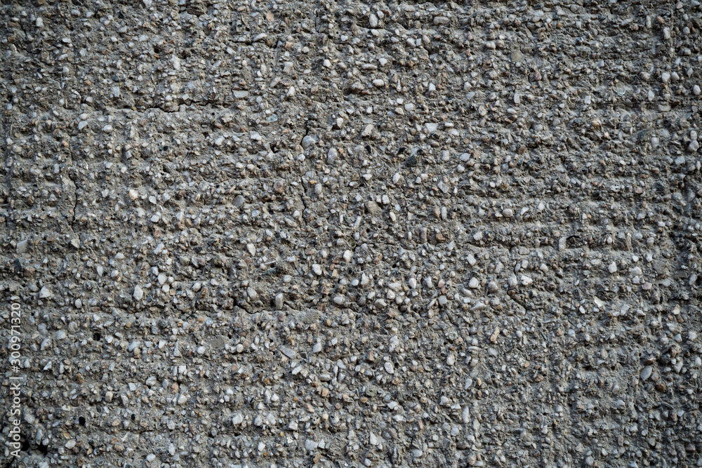 Texture of an old cracked concrete wall. Background image of a worn gray concrete surface Texture of an old cracked concrete wall. Background image of a worn gray concrete surface