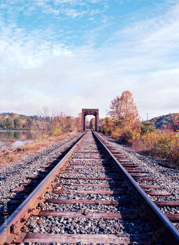 Fototapeta premium Railroad Bridge on the Connecticut River with Fall Foliage All Around