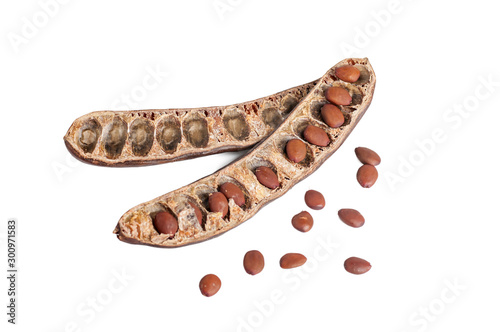 carob opened with seeds isolated on white