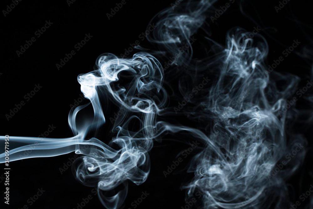 Photo of a wisp of smoke on a dark background Photo of a wisp of smoke on a dark background