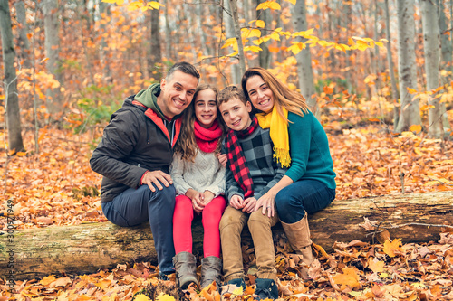 A portrait of a young family in the autumn park