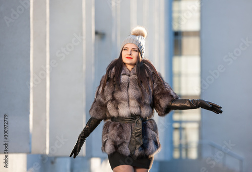  Woman in fur coat, black leather gloves, gray hat © erainbow