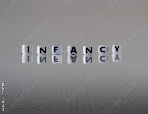 The concept of infancy represented by wooden letter tiles photo