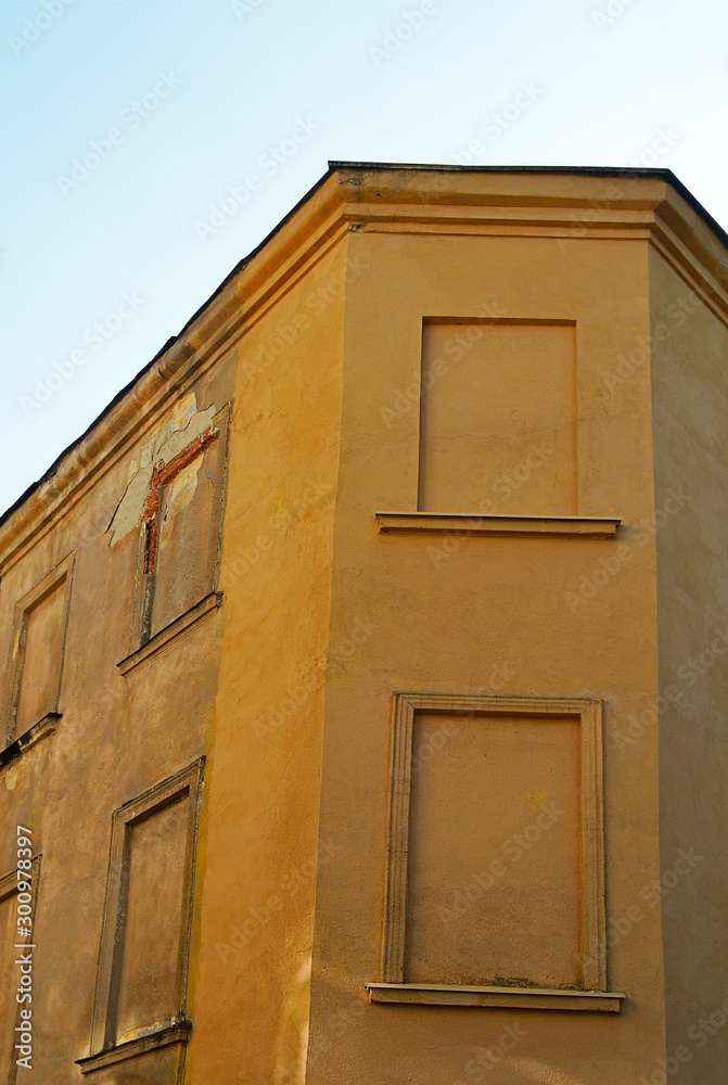 Fototapeta premium Old brown house with bricked-up windows