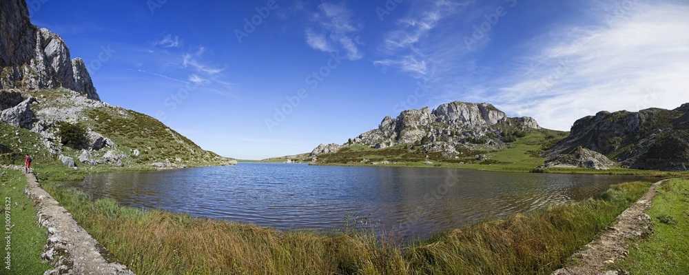 Panoramic flush with the water of the lakes of Covadonga, Asturias. Vertical photo