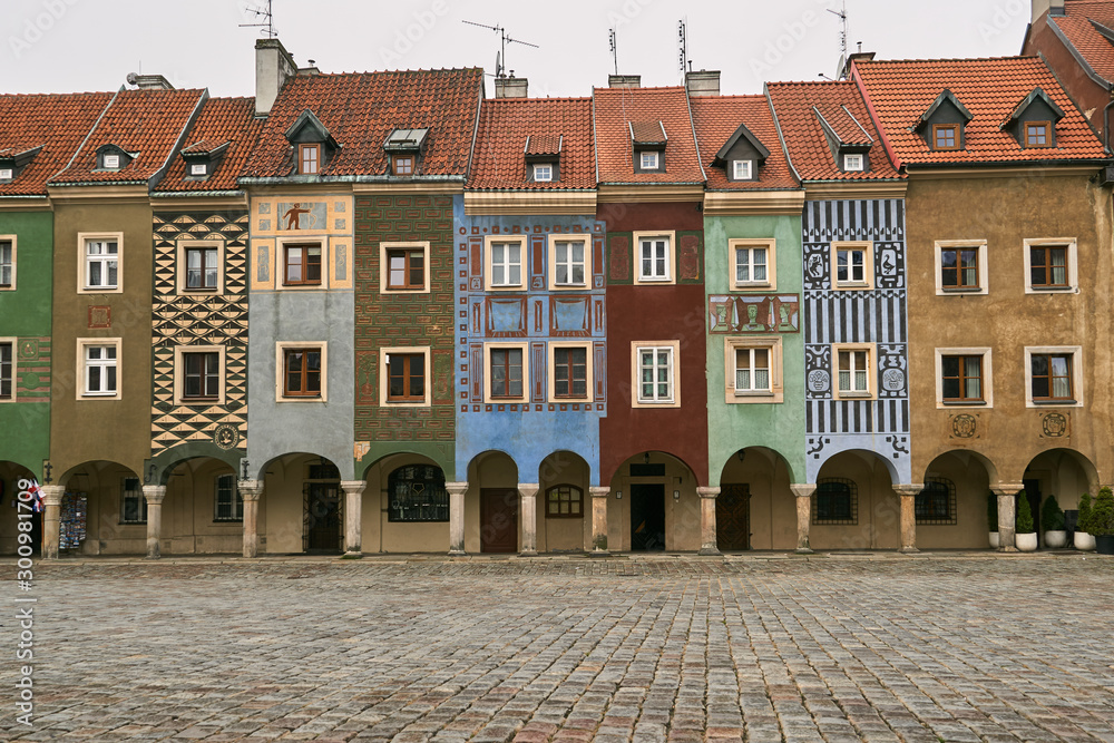 cobbled market and facades of historic tenement houses in Poznan..