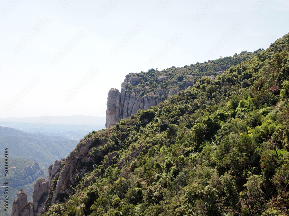 Rocky slopes of Montserrat, covered with dense vegetation.