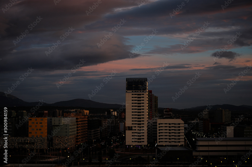 Fototapeta premium Storm clouds in the light of dawn on a dawn of early spring days. Vitoria-Gasteiz (Alava) Basque Country, Spain: salburua neighborhood