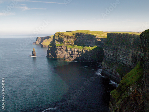 View from top of Cliff of Moher on Atlantic ocean, County Clare, Ireland. Sunny warm day, Blue cloudy sky.
