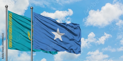 Kazakhstan and Somalia flag waving in the wind against white cloudy blue sky together. Diplomacy concept, international relations.