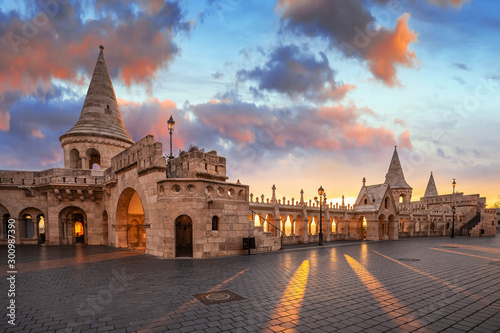 Budapest, Hungary - Beautiful autumn sunrise at Castle district and Fisherman's Bastion with warm sunlight and orange and blue sky and clouds