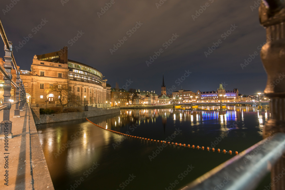 Side view of the Stockholm parliament house at night, long exposure, from the parliament access bridge, Sweden 2019