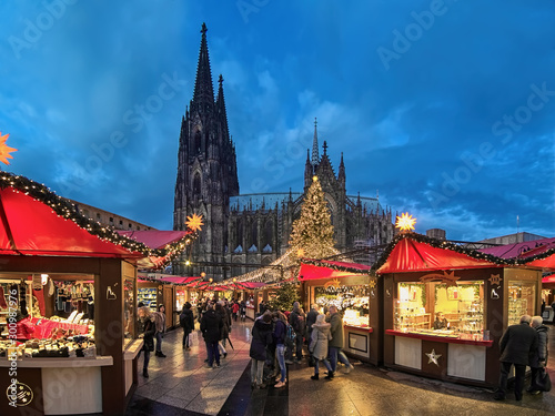Cologne Cathedral Christmas Market in twilight, Germany. This is the most popular and best-known of all the city markets in front of the famous Cologne Cathedral. photo