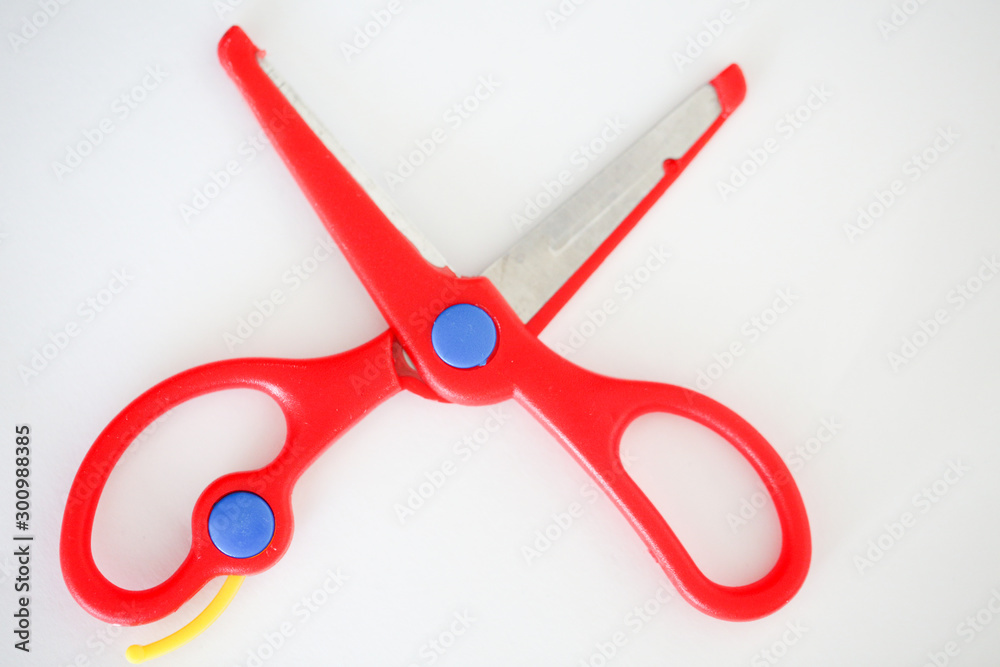 Red handle scissors placed on a white background - Image Red handle scissors placed on a white background - Image