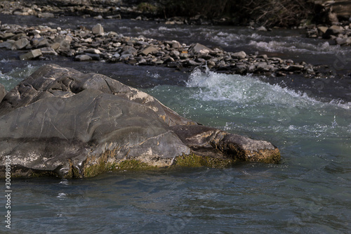 Mountain fast river and stone on the shore, background, Caucasus © liusan 