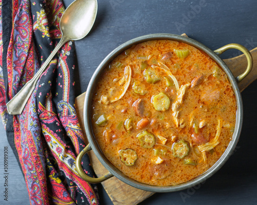 Obraz na płótnie Top view of a pot of gumbo with okra, chicken, tomatoes and sausage