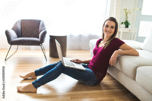 Brunette having good time on the living room with laptop